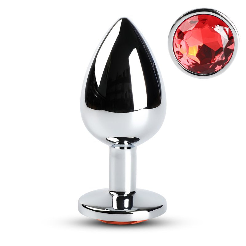 Plug anal de grande taille en métal avec pointe rouge et base large pour sécurité.