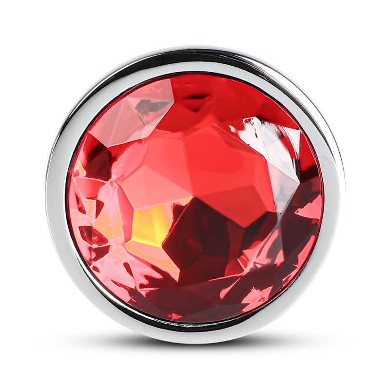 Accessoire intime anal en métal argenté avec extrémité rouge, design lisse.