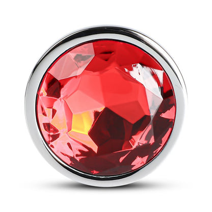 Accessoire intime anal en métal argenté avec extrémité rouge, design lisse.