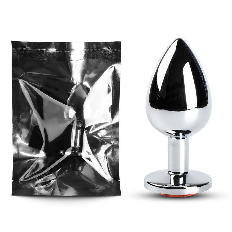Plug anal métallique rouge et argent avec surface lisse et forme conique.