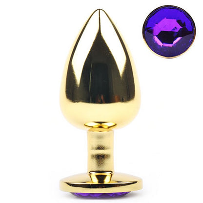Plug anal en métal doré avec base décorée d’un diamant violet